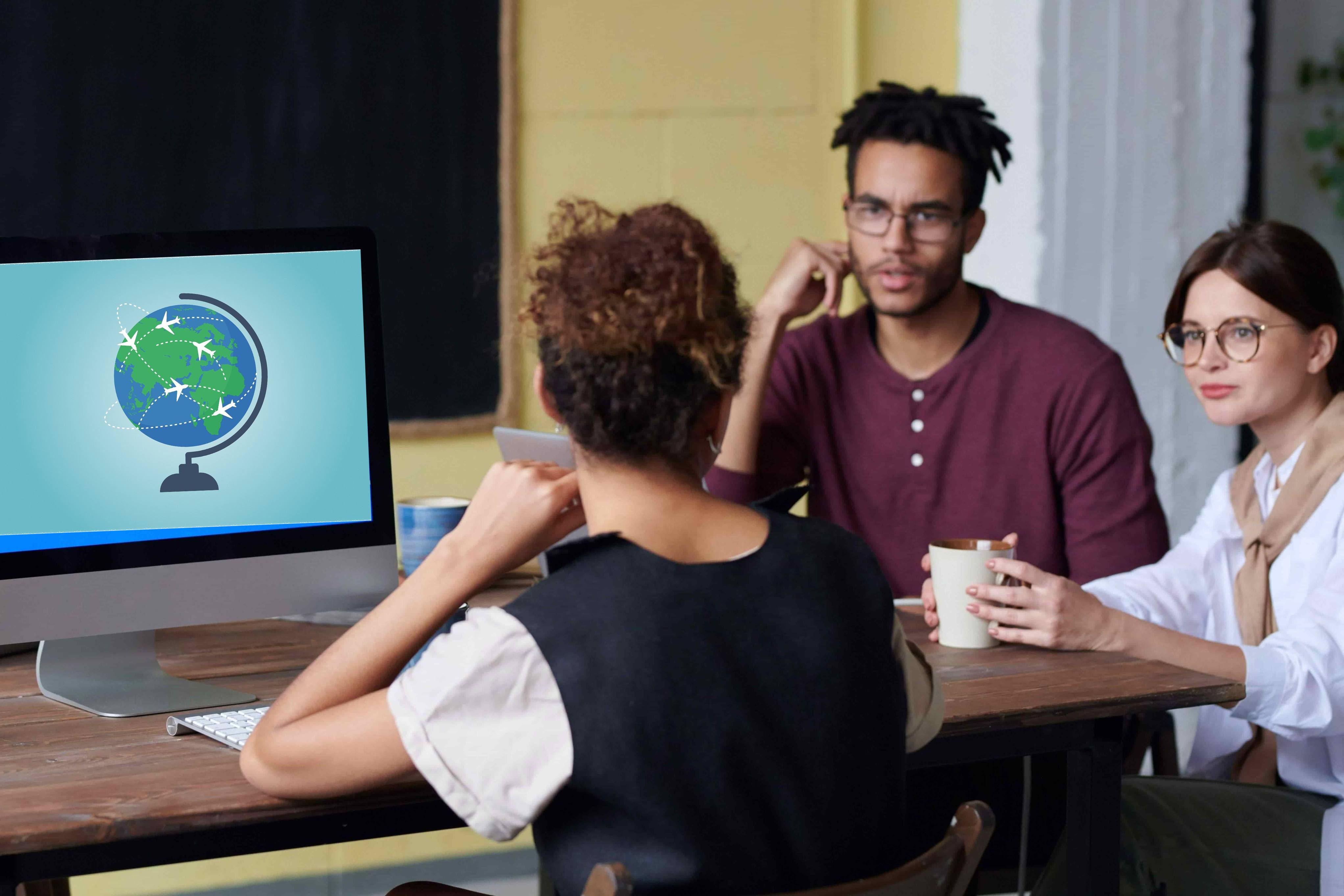 intercultural trainer on a laptop delivering a cross-cultural training programme to a diverse couple