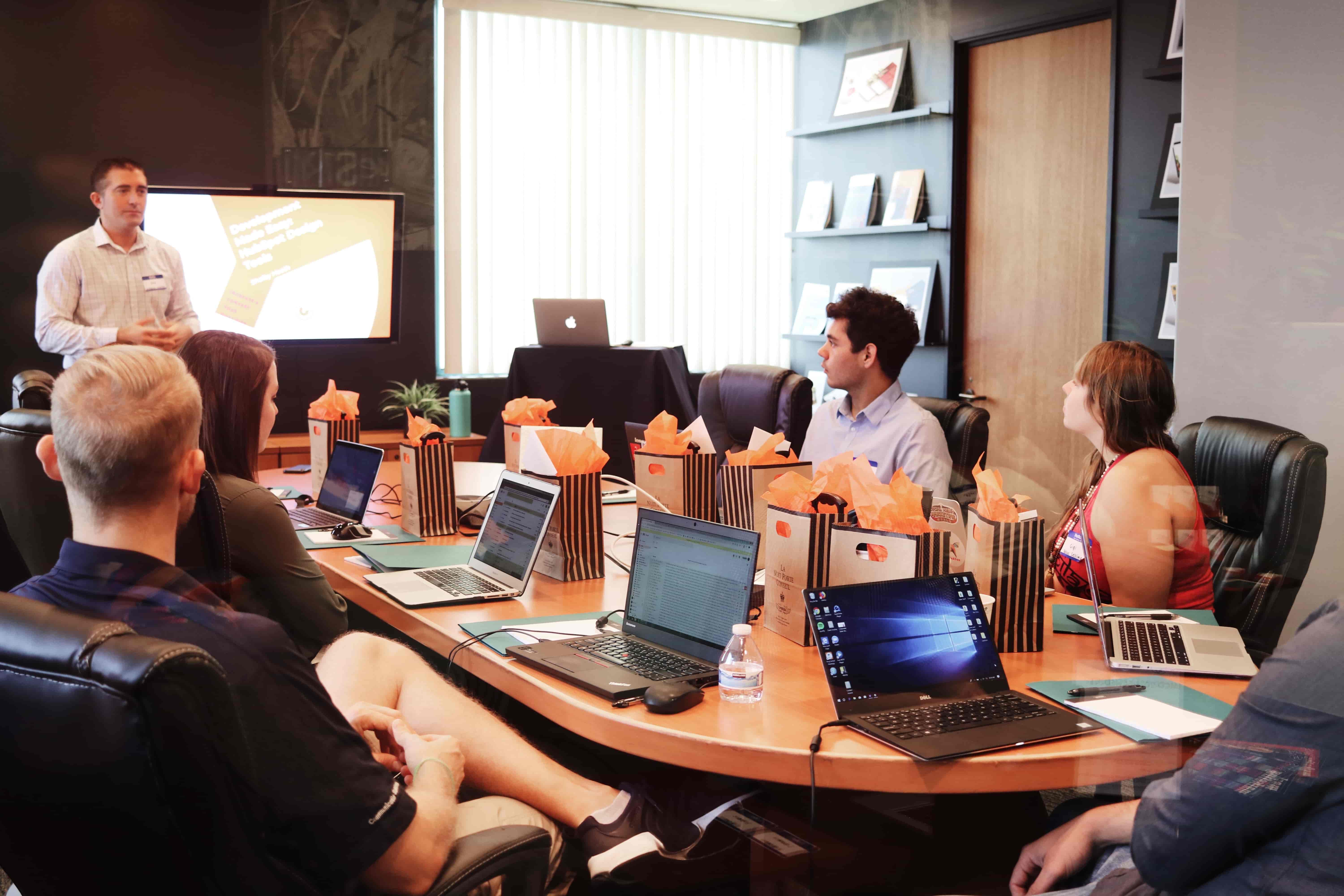 non-native english-speaking professional confidently presenting to his team