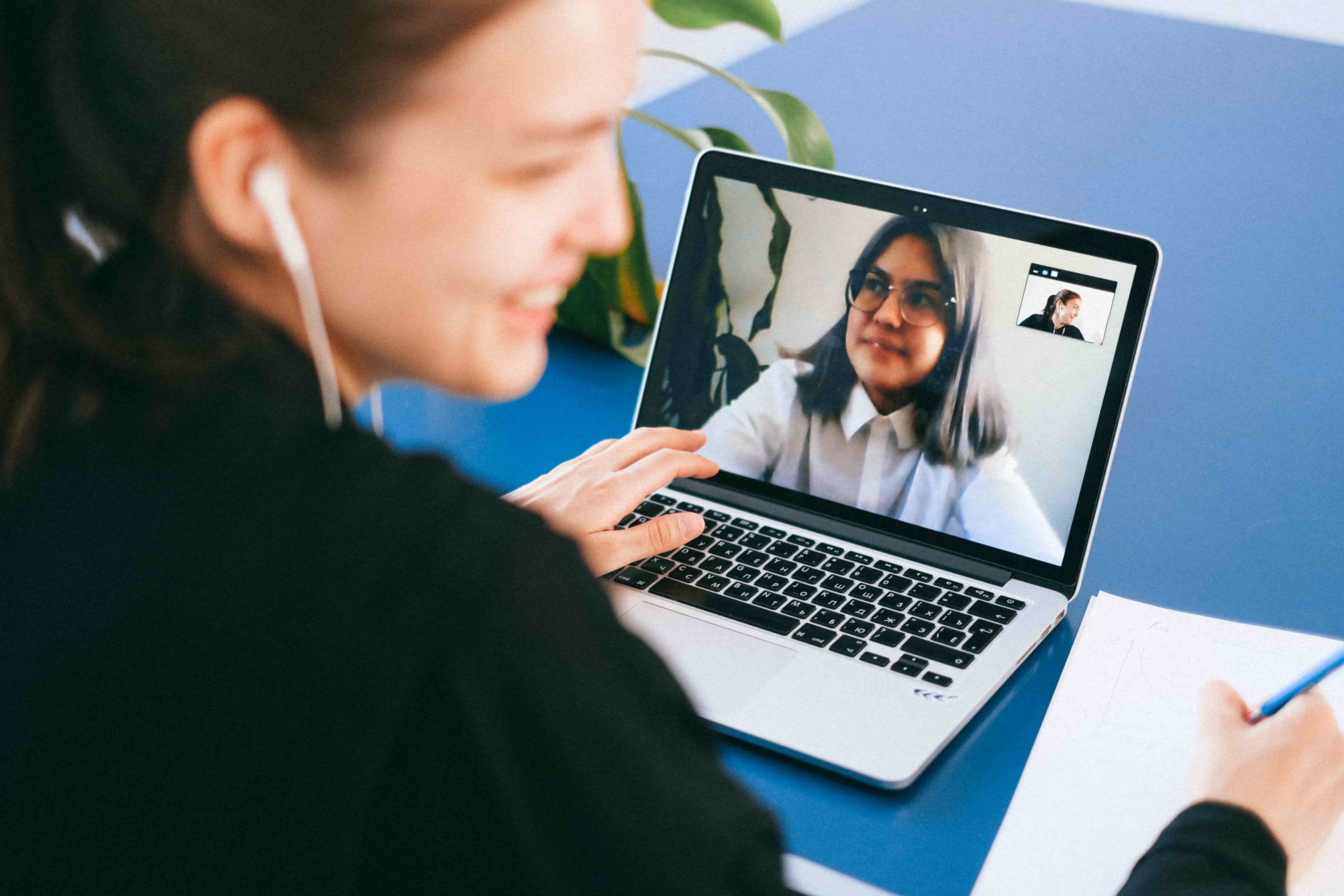 intercultural trainer providing virtual coaching session on a laptop