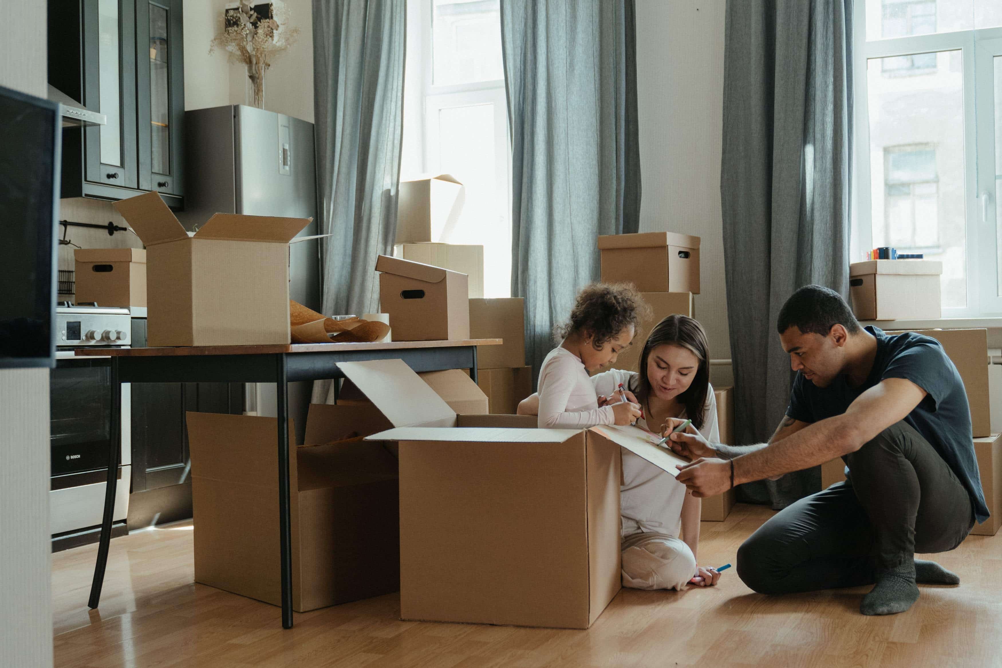 Culturally diverse family pack up boxes to move abroad