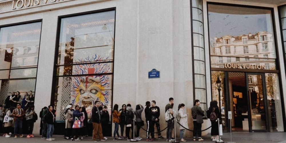 people queueing outside retail store