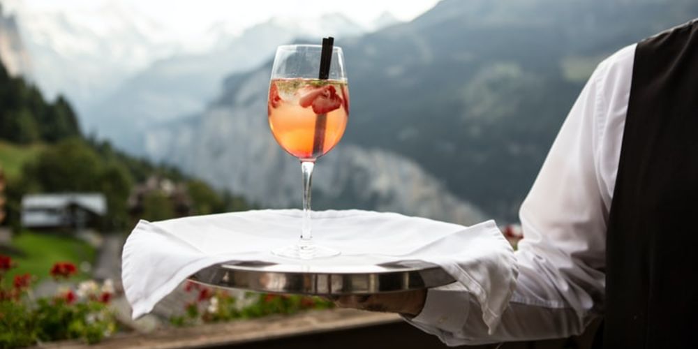 waiter serving drink on a tray