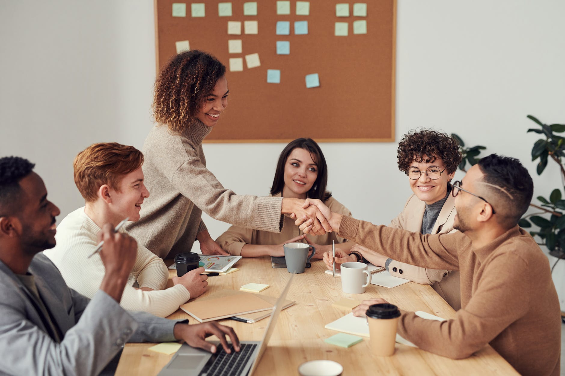 multicultural team shaking hands and holding a meeting