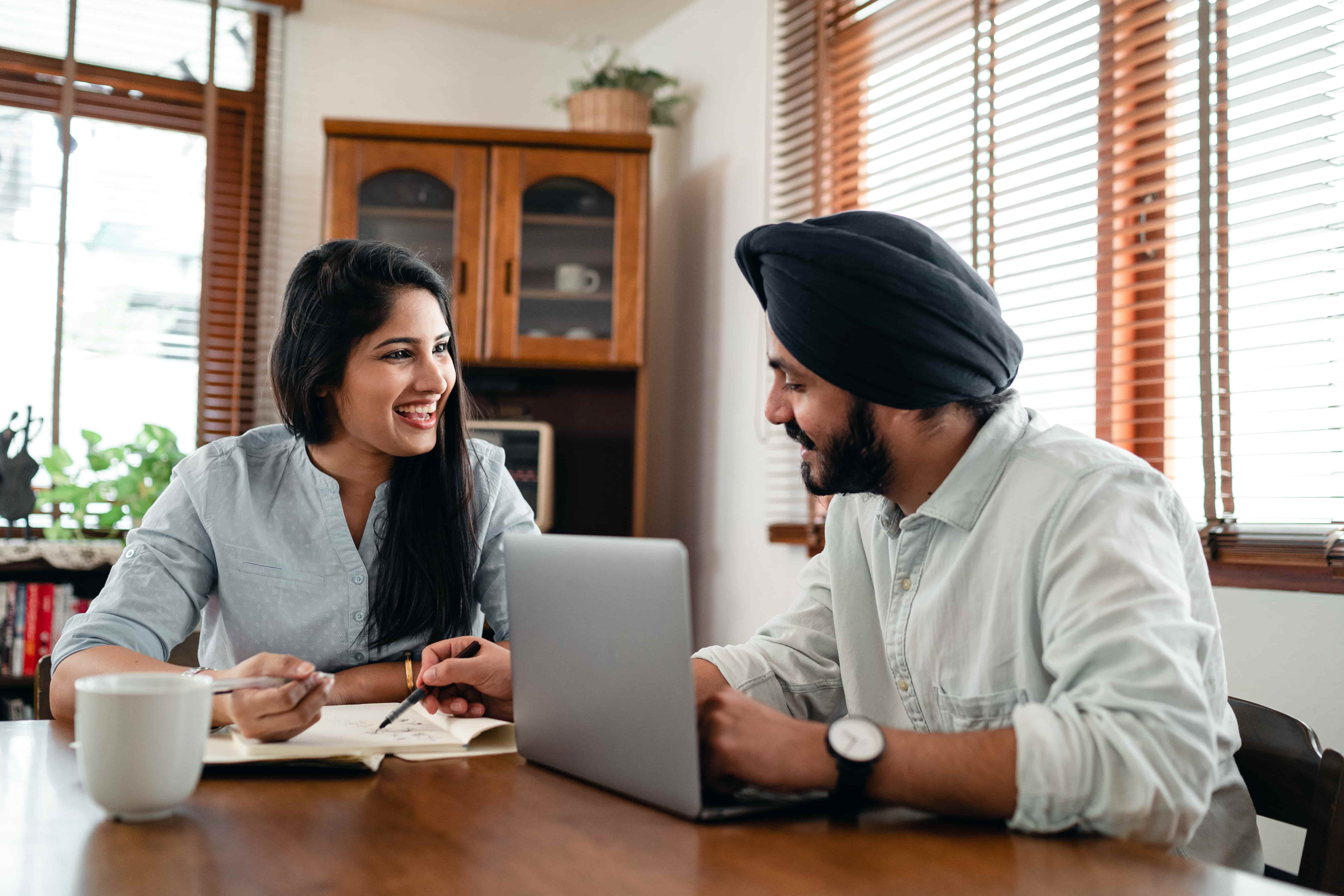 intercultural trainer sitting at table on a laptop with expatriate spouse/partner